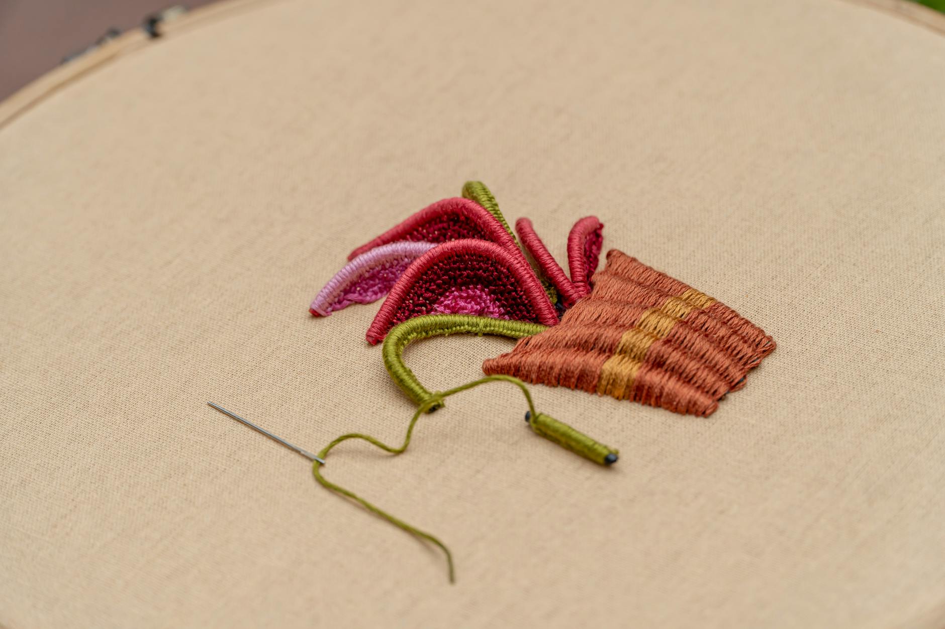 Fabric with colorful cat embroidery design in hoop