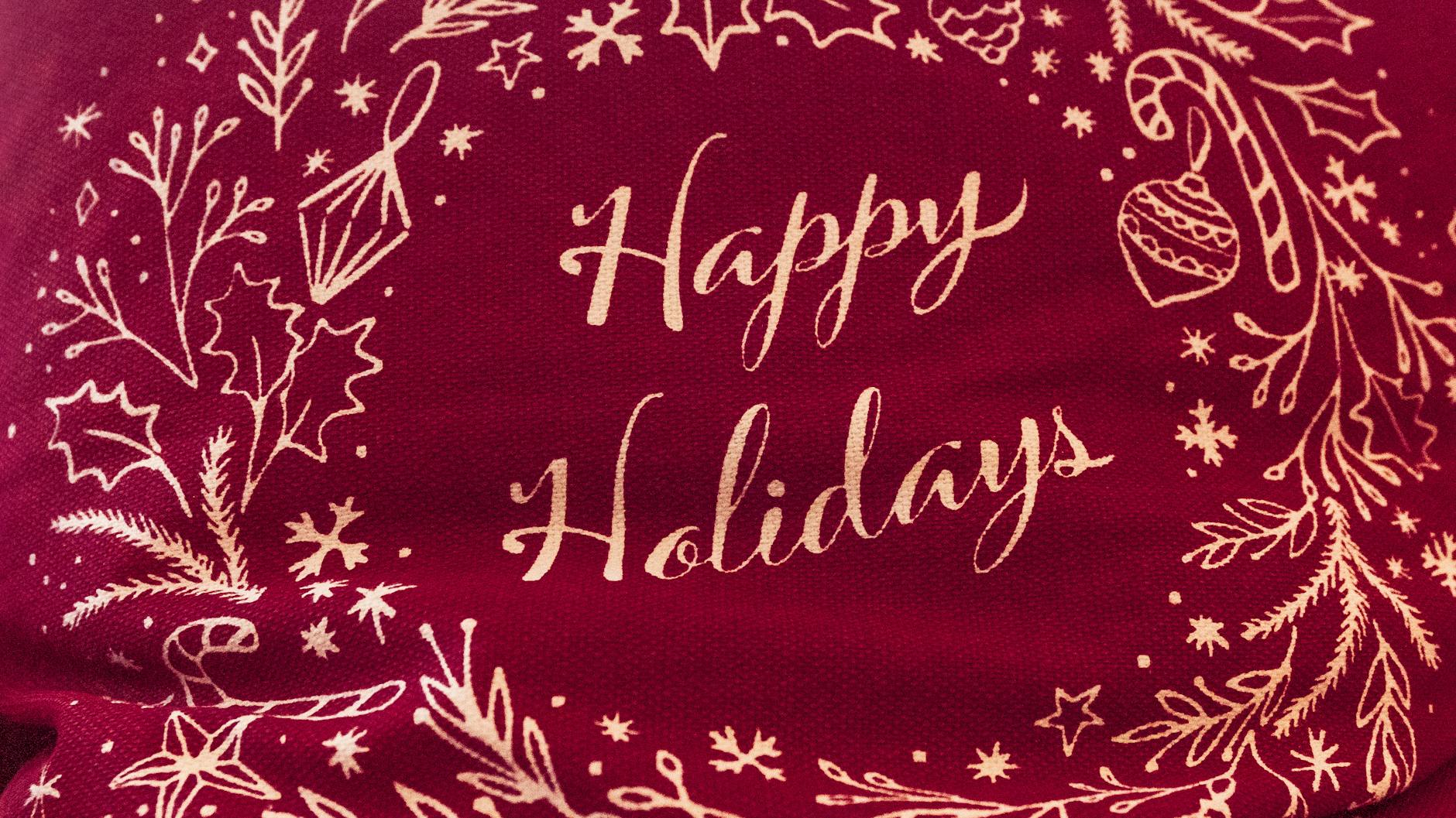 embroidered Christmas ornaments displayed on tree branches