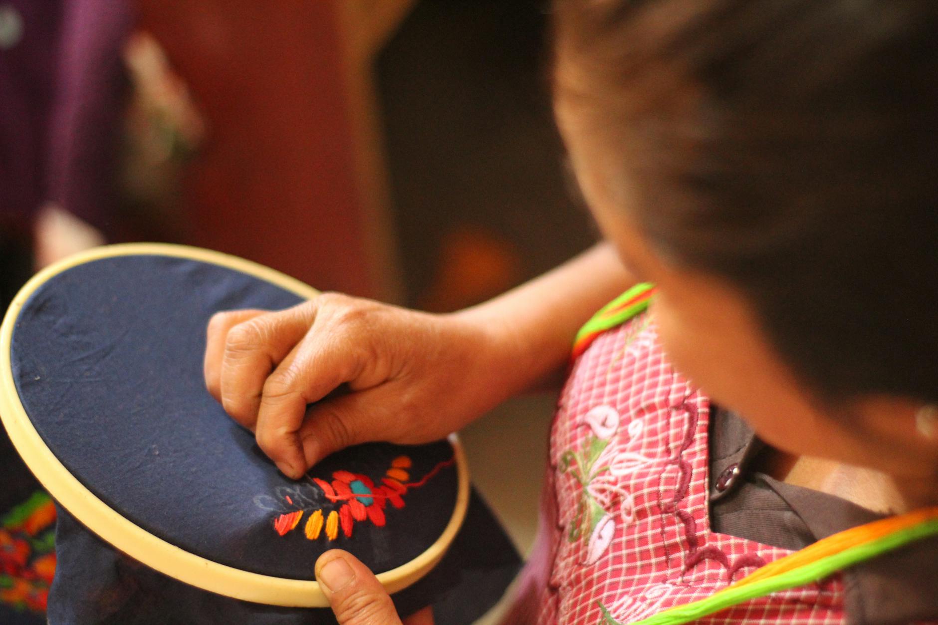 Fabric with machine embroidered fishing-themed designs