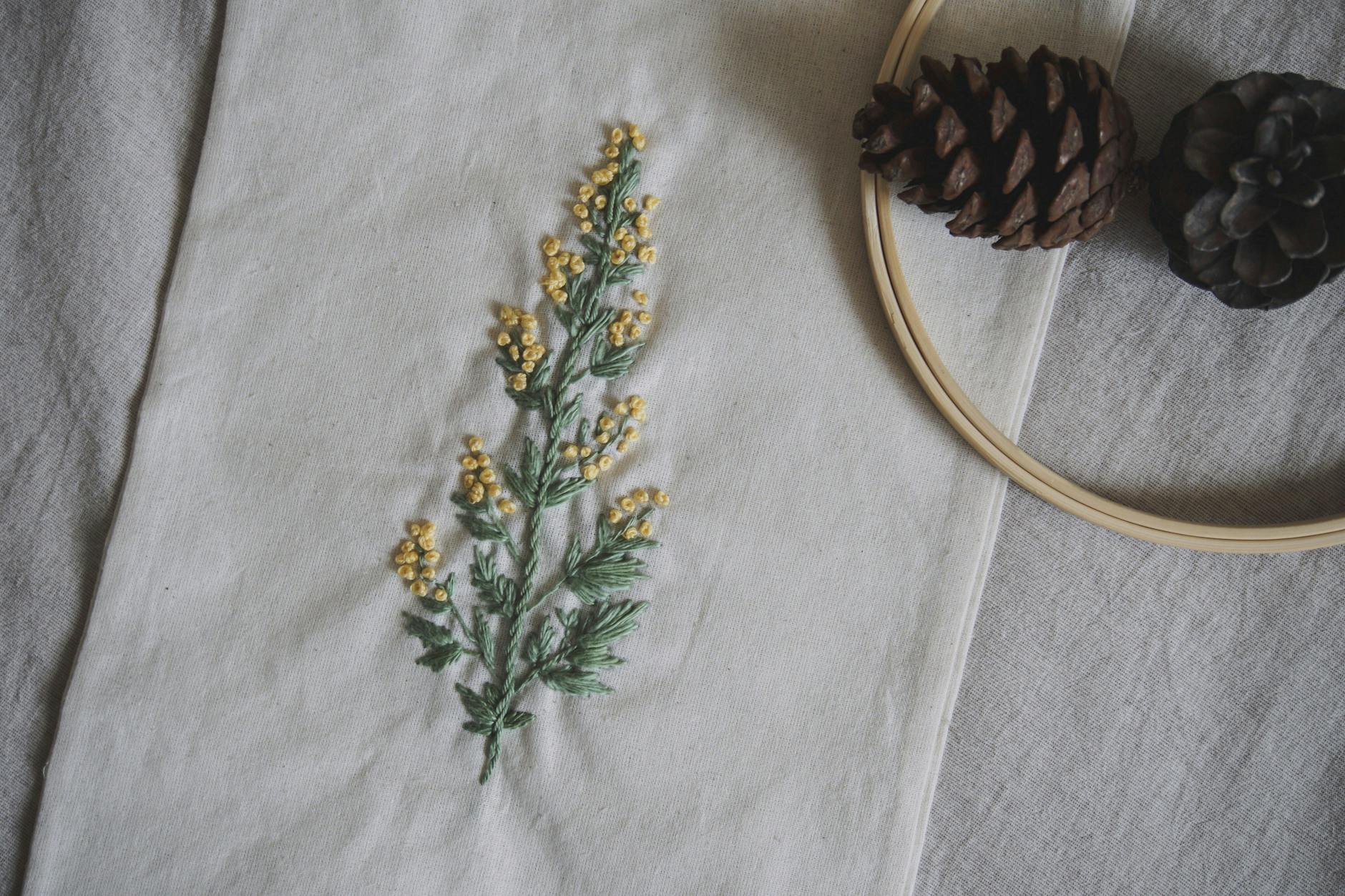 Embroidery machine stitching floral designs on fabric