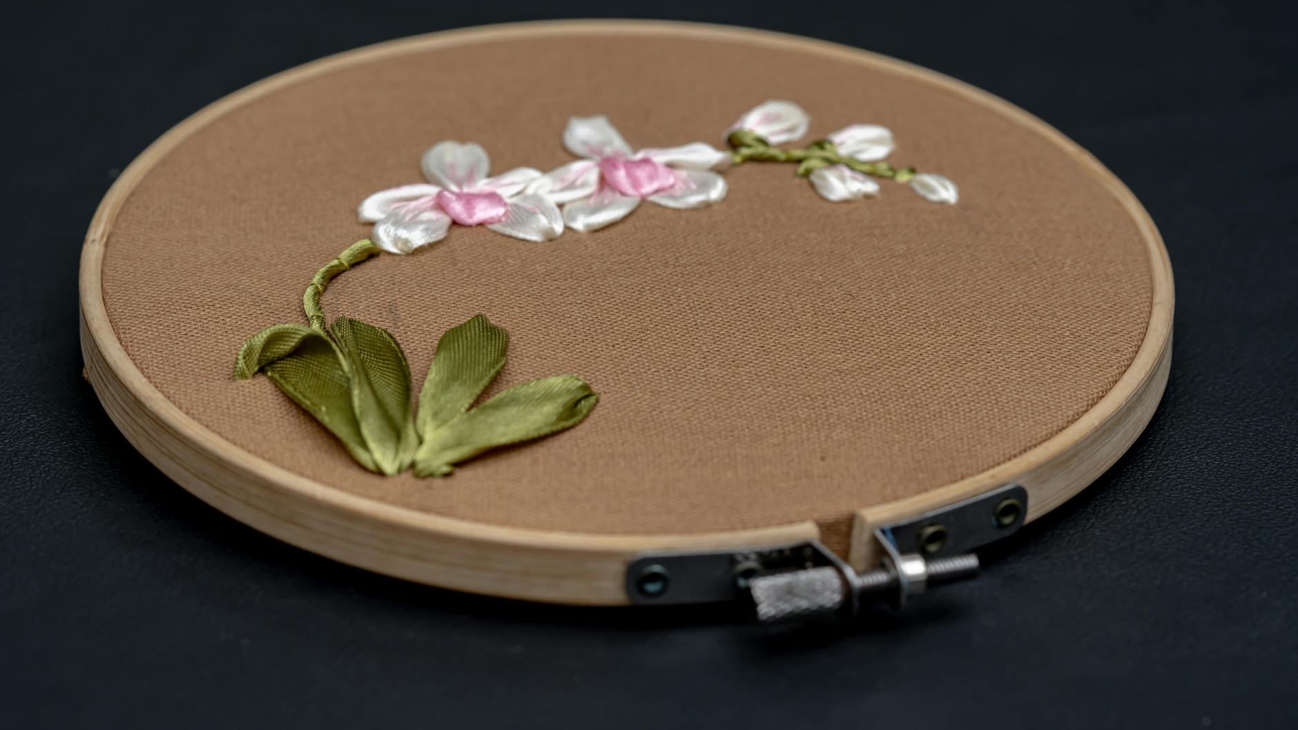 embroidery machine stitching Bluey and Bingo designs on fabric